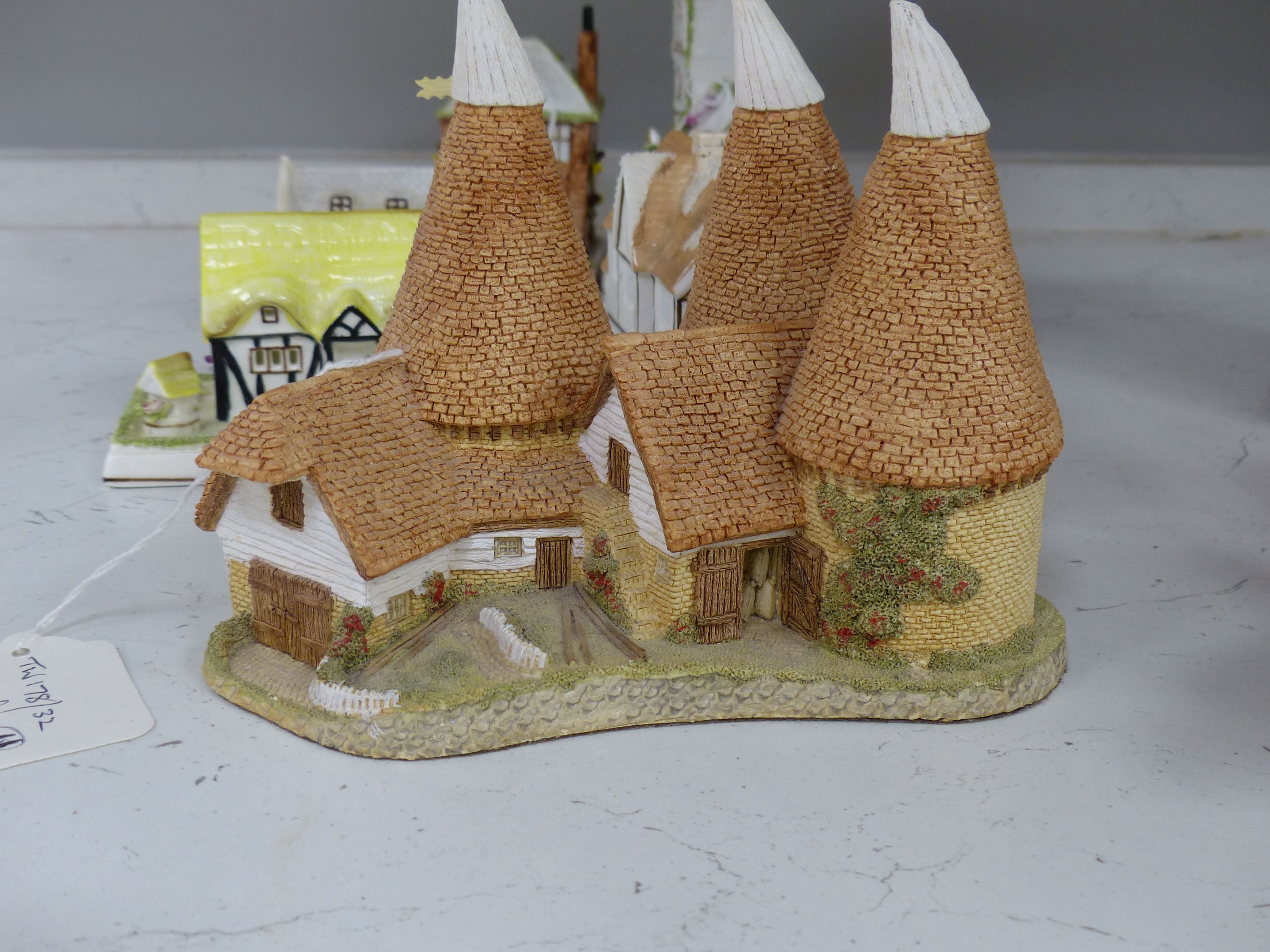 Seven Coalport bone china 'cottage' pastille burners and four similar resin examples (11)